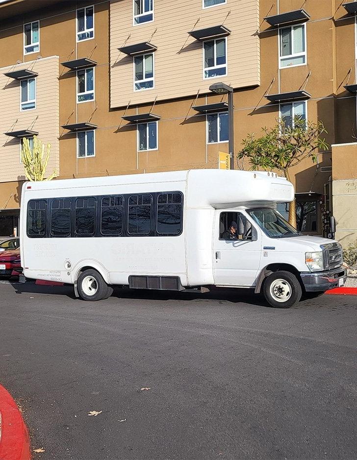 a white sagehen shuttle sits parked in mesa parking lot